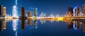 Fascinating reflection of tallest skyscrapers in Business Bay district during calm night. Dubai, United Arab Emirates. Fascinating reflection of tallest skyscrapers in Business Bay district during calm night. Downtown summer night. Construction built at night time. Dubai, United Arab Emirates.